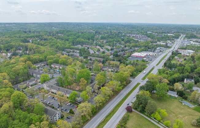 A bird's eye view of a residential area with a road running through it.