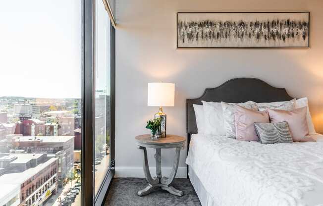 a bedroom with a bed and a large window