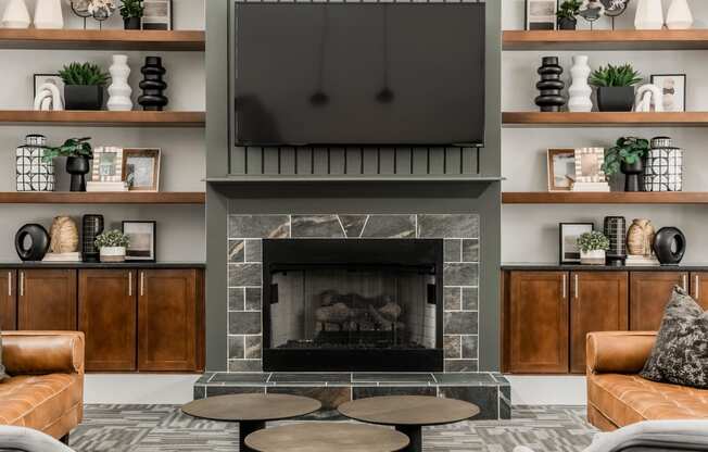 a living room with a fireplace and a tv above it