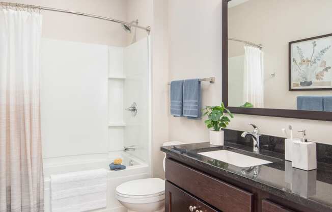 View of spacious, modern bathroom at The Whitley apartments.