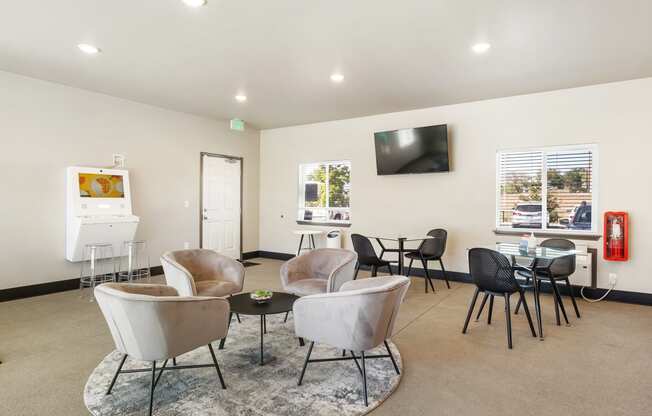 a room with chairs and a table with a television on the wall  at Altitude, East Wenatchee, WA