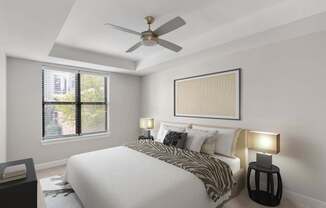 A bedroom with a bed, a ceiling fan, and a window with blinds.