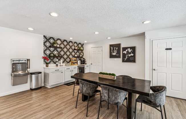 A modern dining room with a wooden table and chairs.