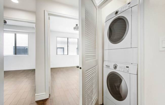 a washer and dryer in a white laundry room