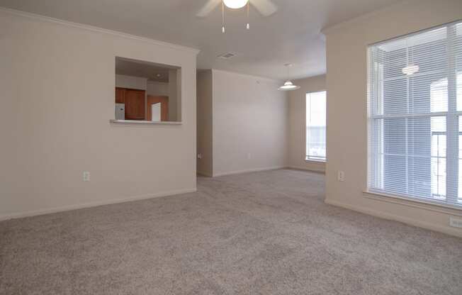 an empty living room with a large window