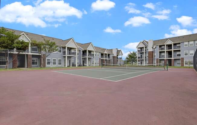 Large tennis court with apartments in the background Apartments for rent Springdale AR