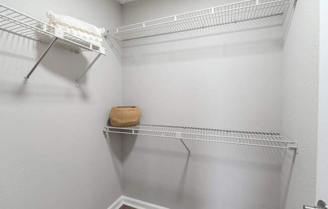 A white shelf with a brown bag on it.