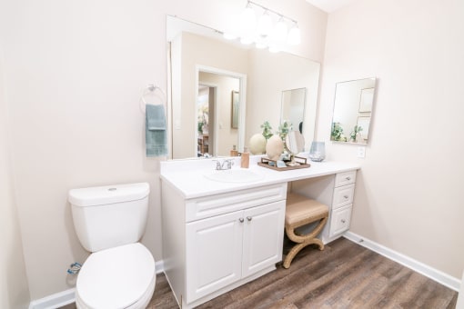 a white bathroom with a toilet and a sink