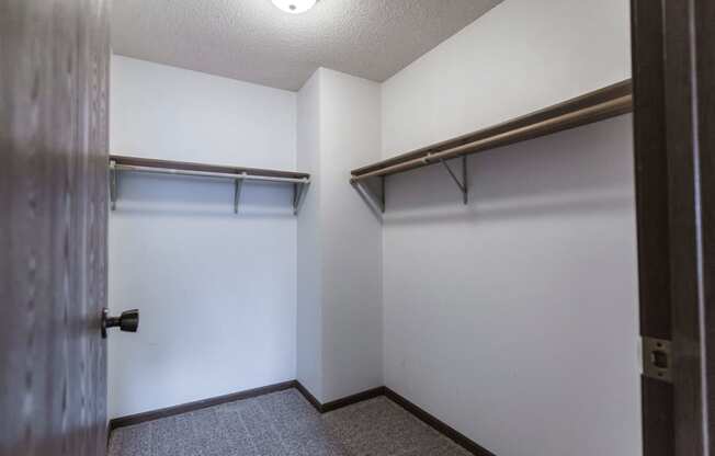 Grand Forks Primrose Apartments. A small room with a white wall and a wooden door