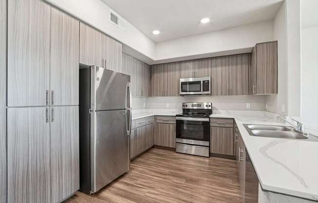 A modern kitchen with wooden cabinets and stainless steel appliances.