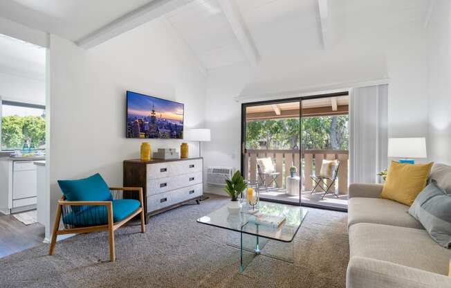 a living room with a couch and a glass coffee table