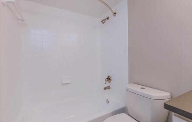 a white tub sitting next to a shower