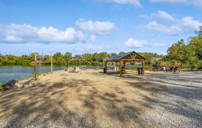 a picnic pavilion with a lake in the background