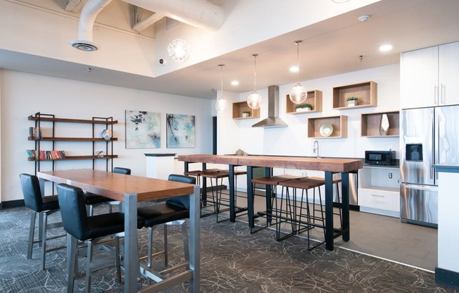 A modern kitchen with a dining table and chairs.