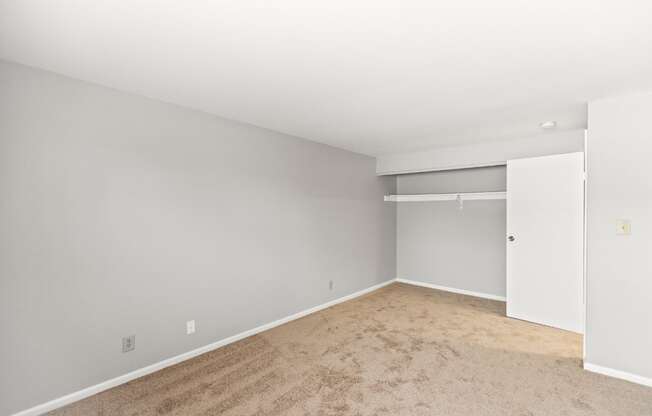 A room with a carpeted floor and white walls.