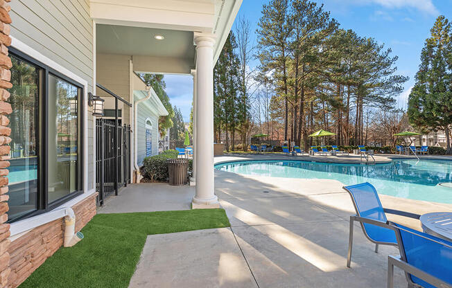 Community Swimming Pool with Pool Furniture at Shadow Ridge Apartments in Riverdale, GA.