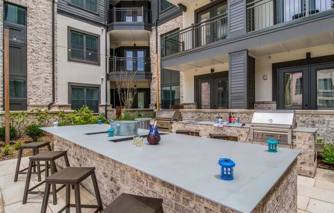 Barbecue Area in Courtyard at The Alastair at Aria Village Apartment Homes in Sandy Springs, Georgia, GA