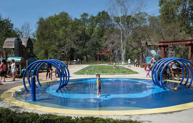 a child plays in a water park  at Falcon Bridge at Gale Ranch, San Ramon