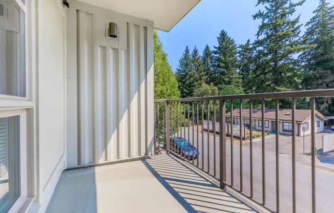 a balcony with a view of a parking lot and trees  at Delano, Redmond