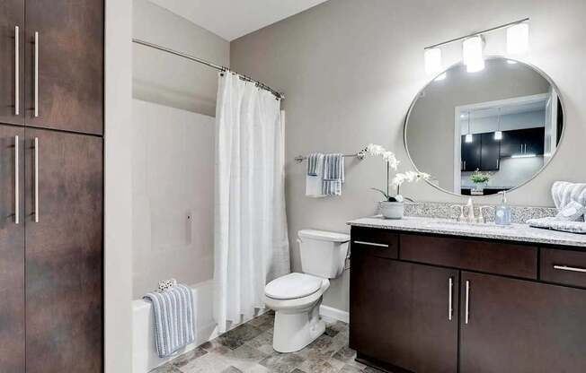 a bathroom with a white toilet and a sink. Circle Pines, MN Lexington Lofts