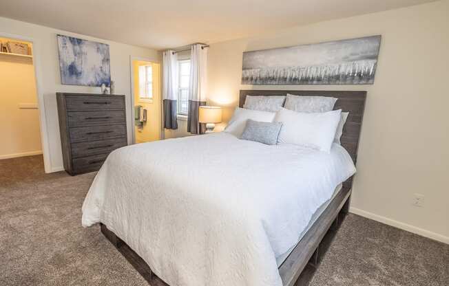 a bedroom with a large bed and a dresser at Chapel Valley Townhomes, Baltimore