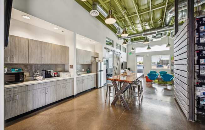 a kitchen with white cabinets and a table with chairs