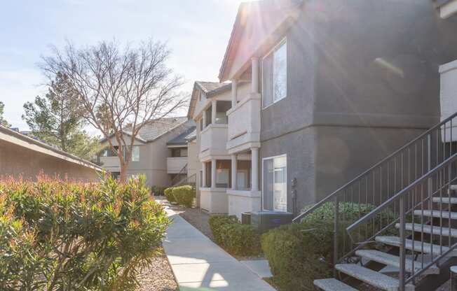 a row of houses with stairs and a sidewalk