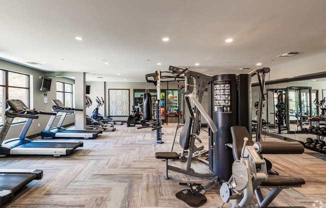 fitness center with cardio and weigh machines