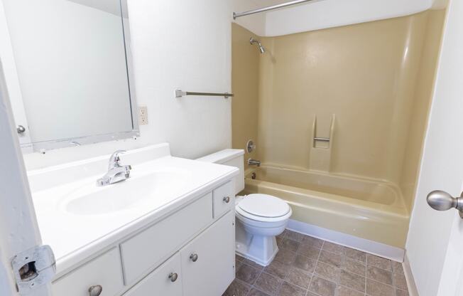 a bathroom with a sink toilet and a tub