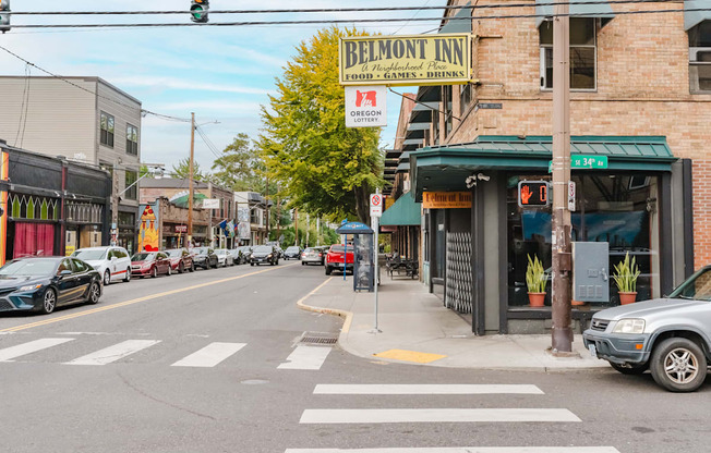 A street view of Belmont Inn with cars parked on the side of the road.