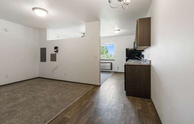 A room with a brown floor and white walls.