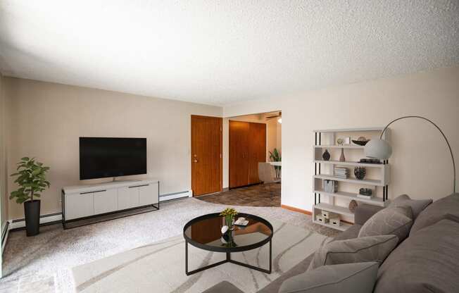 A living room with a couch and a coffee table. Bismarck, ND Eastbrook Apartments.