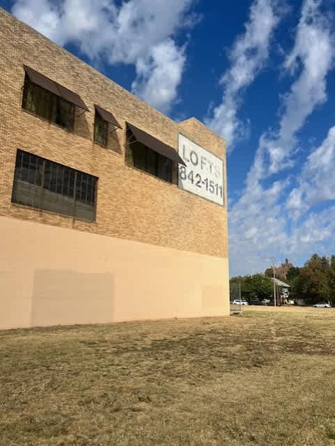 A Lofts sign is on a building with a blue sky in the background.