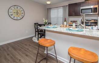 kitchen and dining room with orange stools Brittany Place Apartments in Norfolk VA