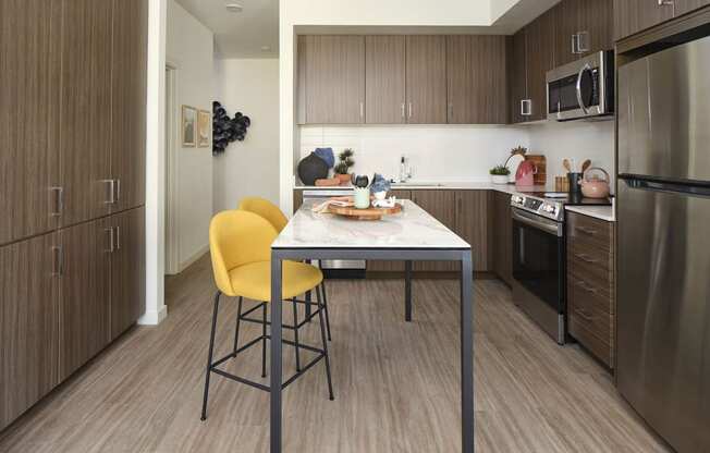 a kitchen with a table and chairs