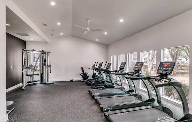 the gym has cardio machines and treadmills and large windows