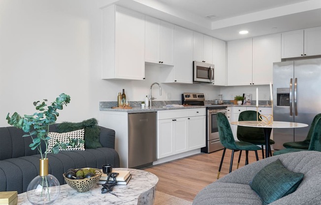 a living room and kitchen with a couch and a table