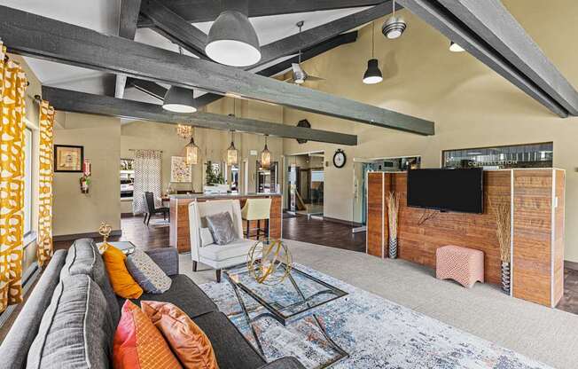 A living room with a grey couch and a wooden cabinet.