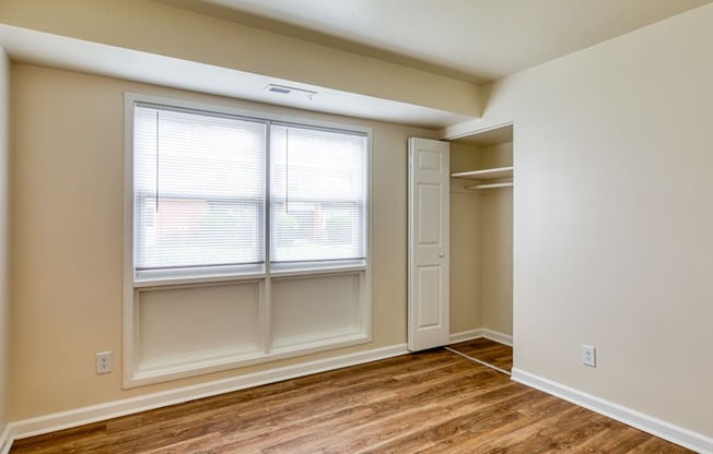 an empty bedroom with a window and a closet at Gates of West Bay in Virginia 23503