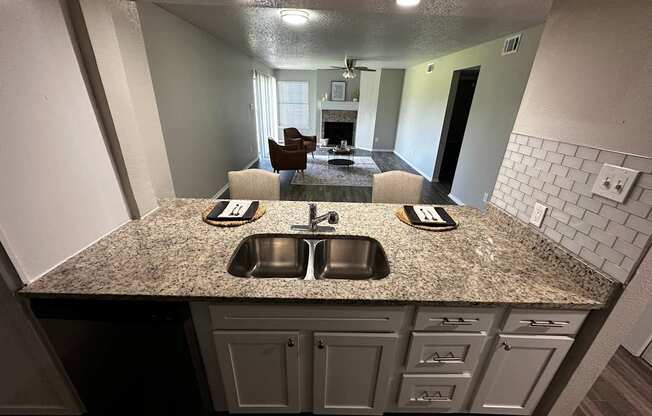 A kitchen with granite countertops and a sink.