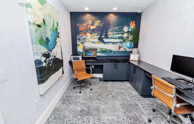 an office with a large painting on the wall