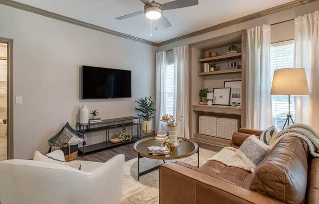 a living room with a couch and a tv at Reserve by the Lake, Houston, Texas