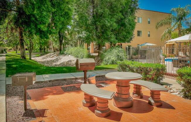 a picnic area with benches and tables in a courtyard