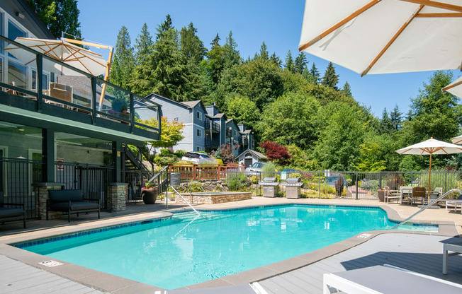 a swimming pool in the backyard of a house with a pool