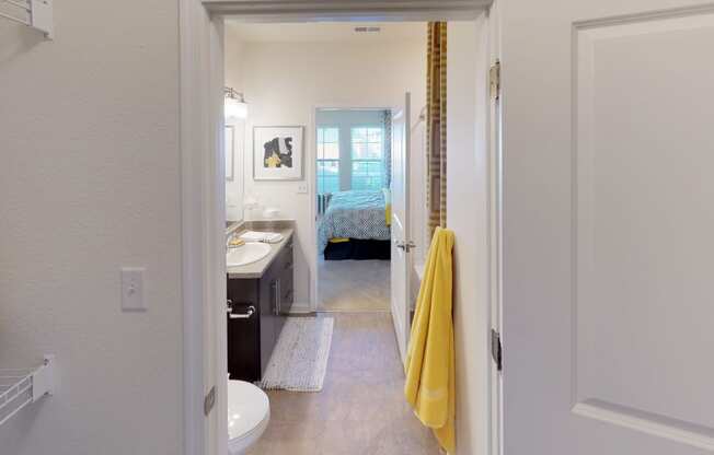 Walk-in closet leading into bathroom; inside main bedroom