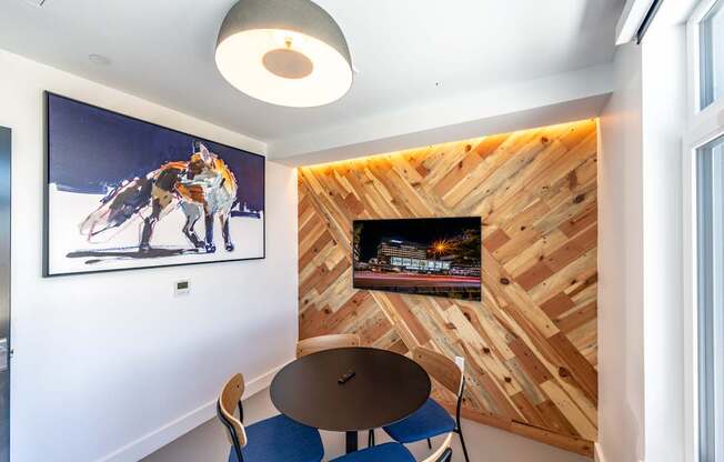 A room with a wooden wall and a picture of a horse on the wall.