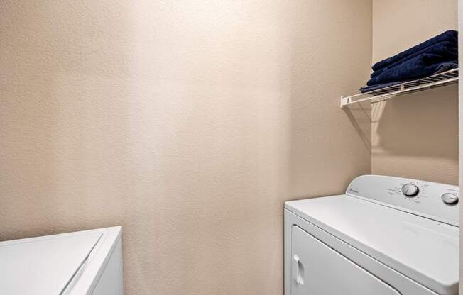 A white washing machine and dryer in a laundry room.