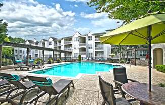pool with sundeck and patio seating