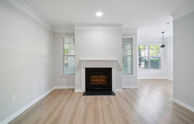 a living room with a fireplace and wooden floors
