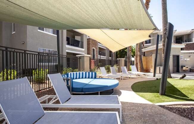 North Phoenix Luxury Apartments -Ironhorse at Tramonto Outdoor Lounge with Chairs and Large Couch Near the Swimming Pool